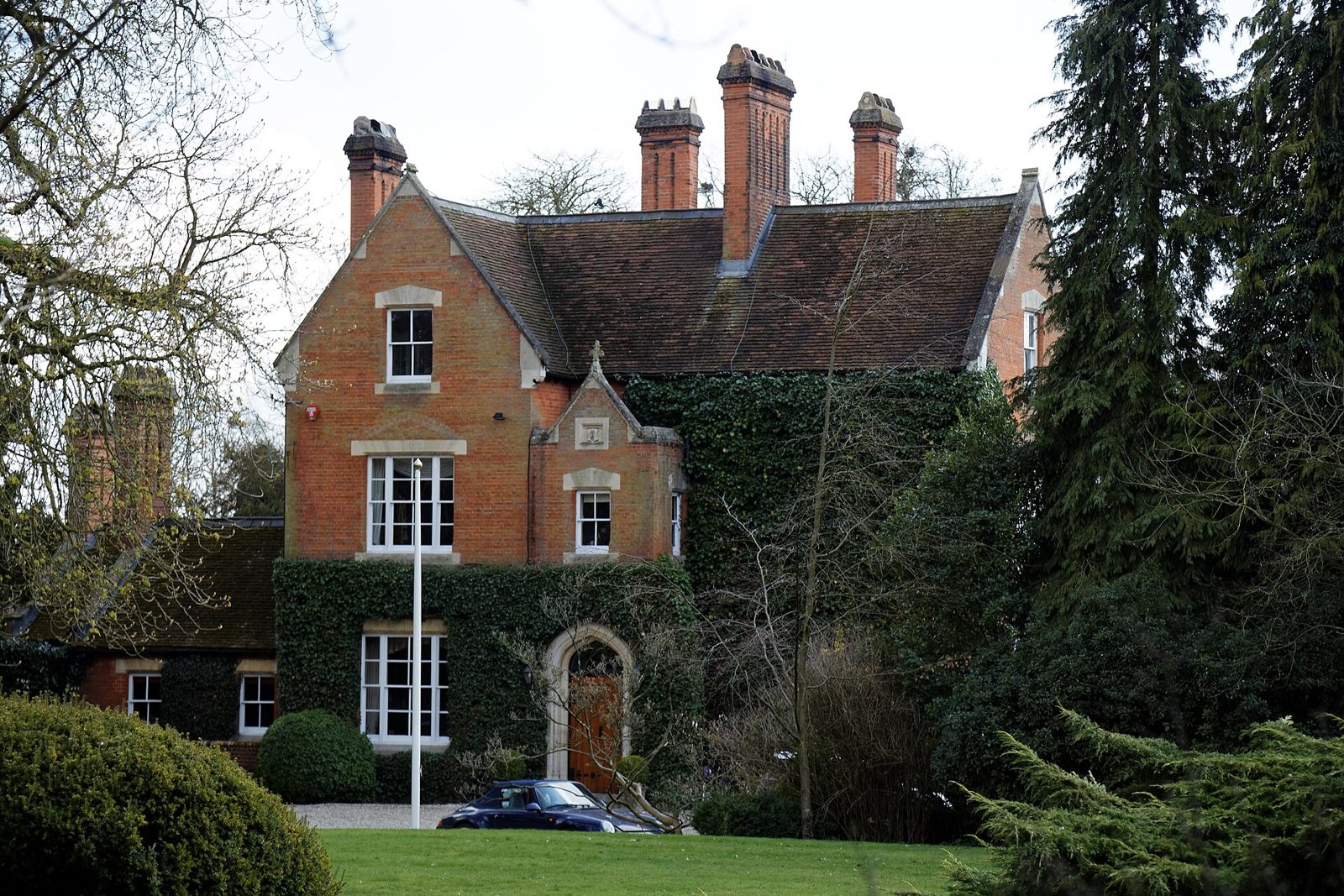 Victorian brick house with tall chimneys and tiled roof