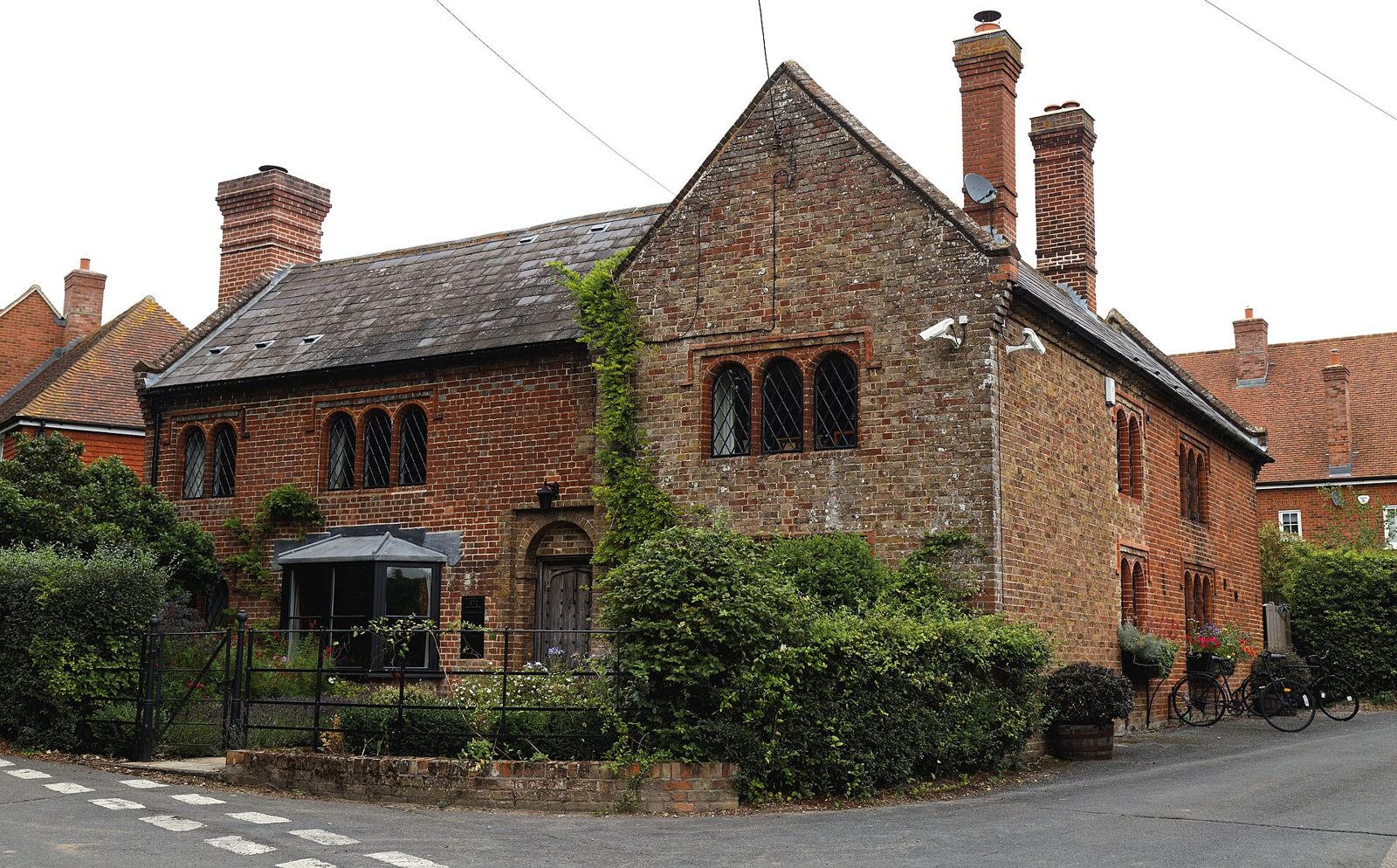 Brick house with gabled tiled roof and chimneys