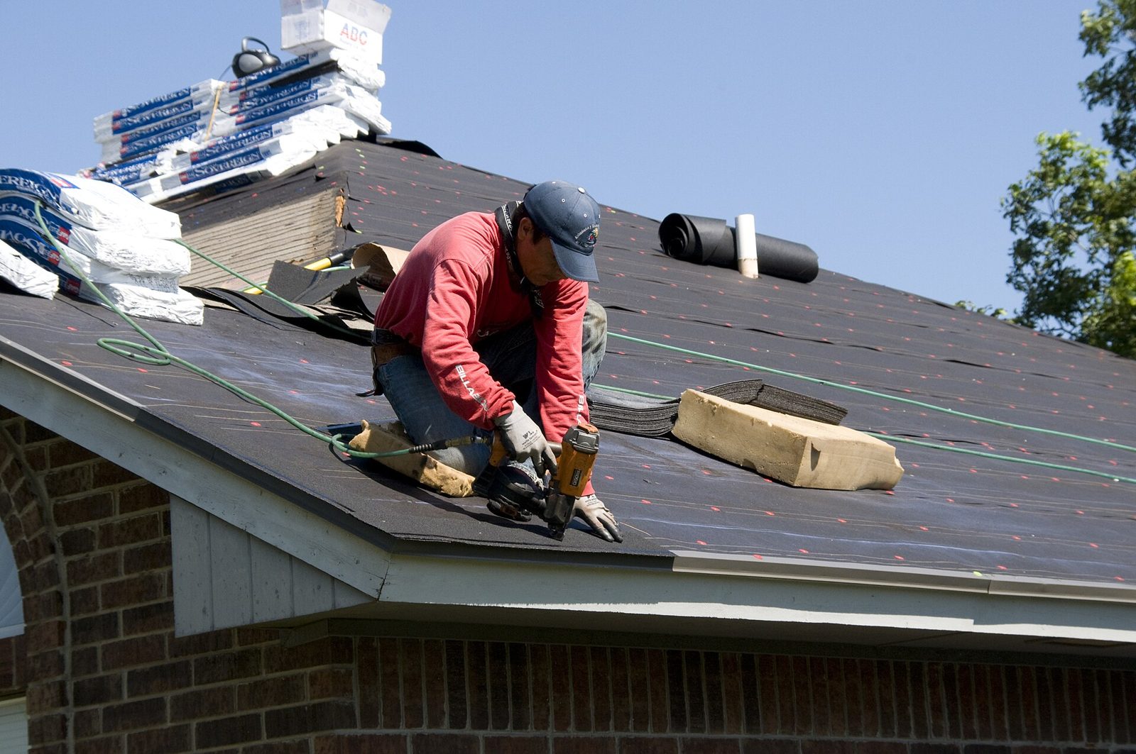 Roofer fitting a new roof covering