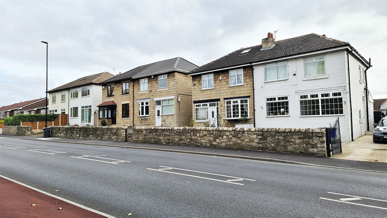 Street of modern semi-detached English homes with pitched roofs