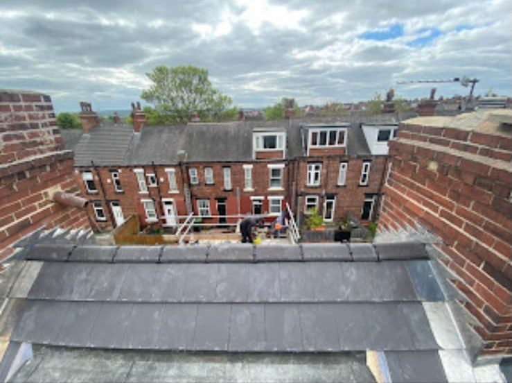 Newly finished flat roof between brick parapet walls