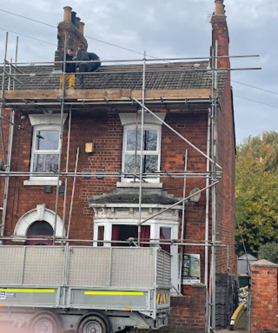 Scaffolding up on a brick house for a full re-roof