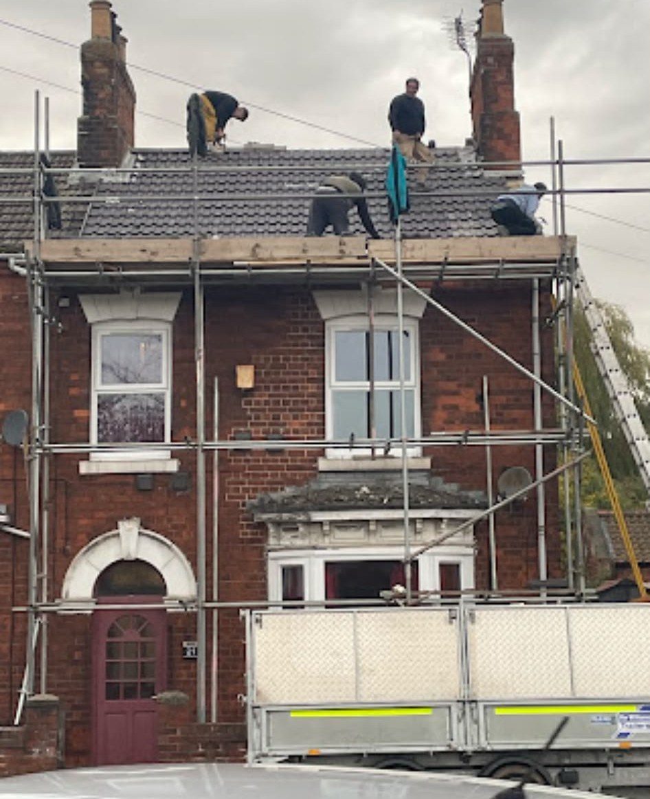 Scaffolding up on a brick house for a full re-roof