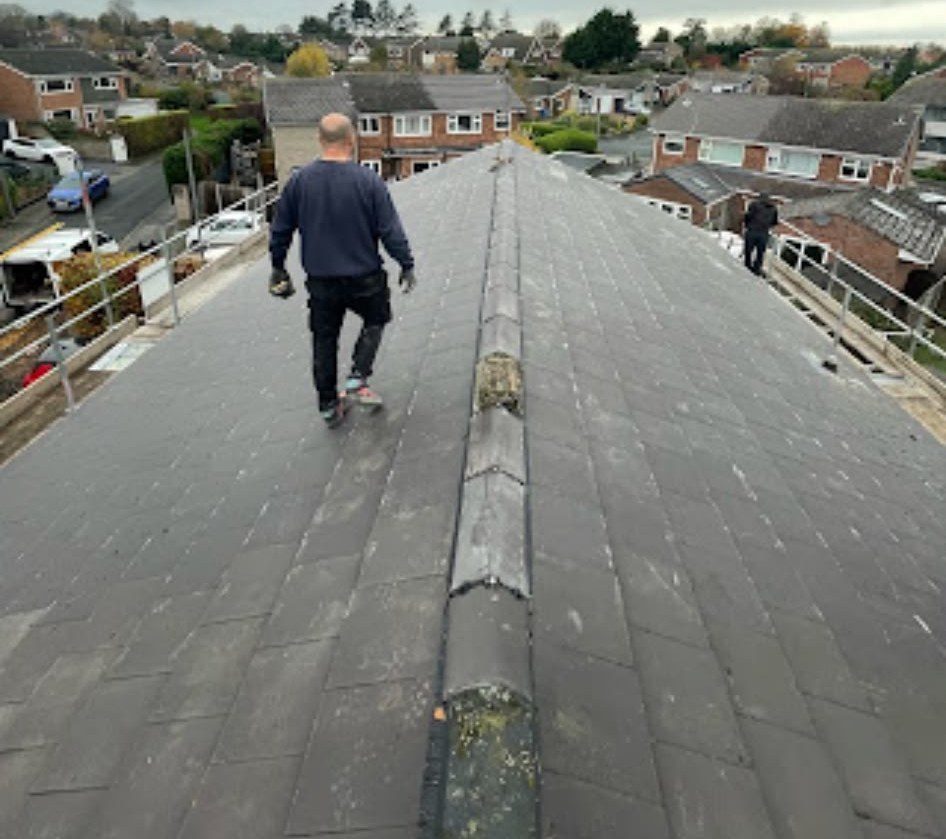 Our roofer walking the ridge of a newly tiled roof