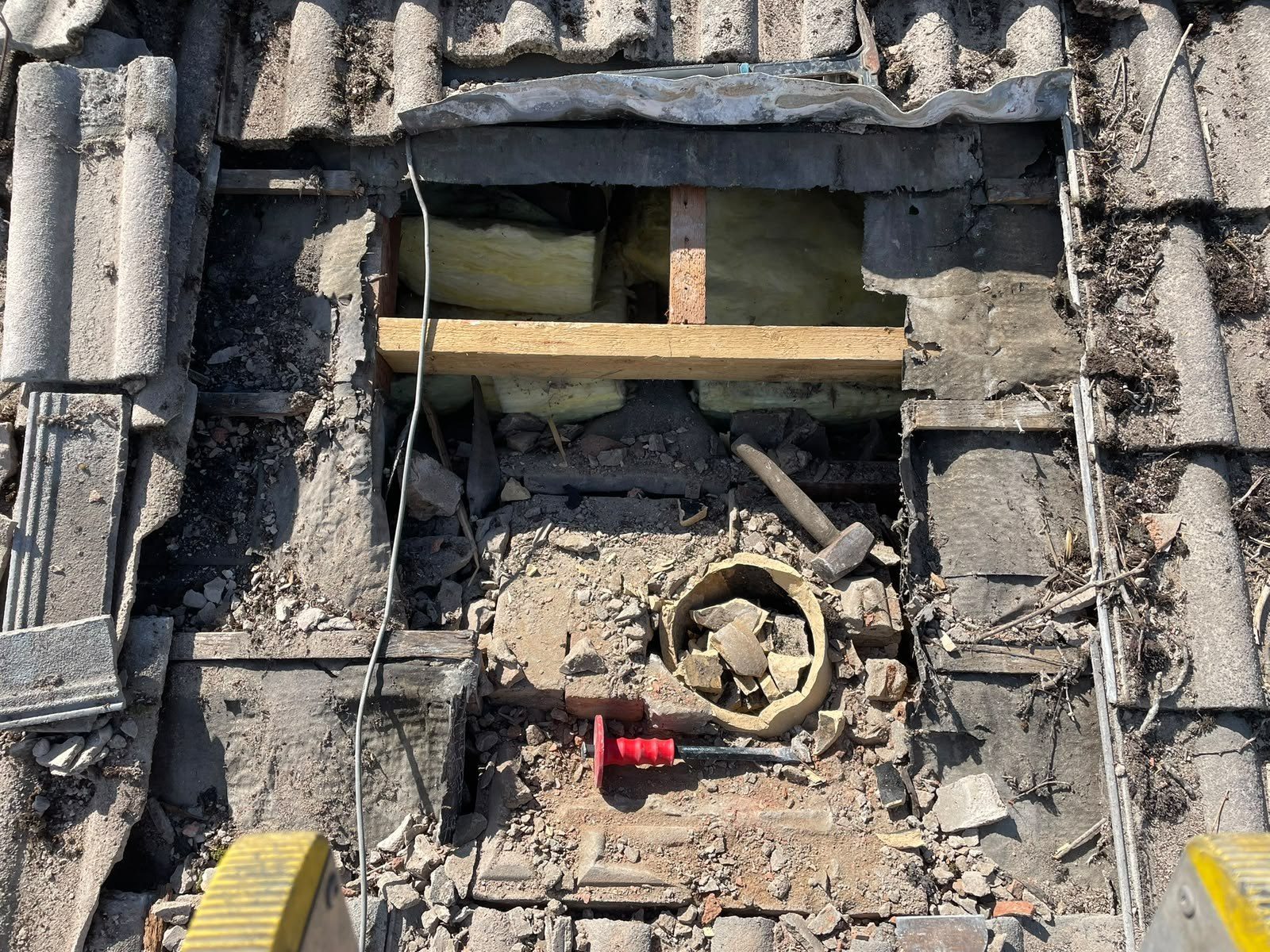 Storm-damaged roof opened up for an urgent repair