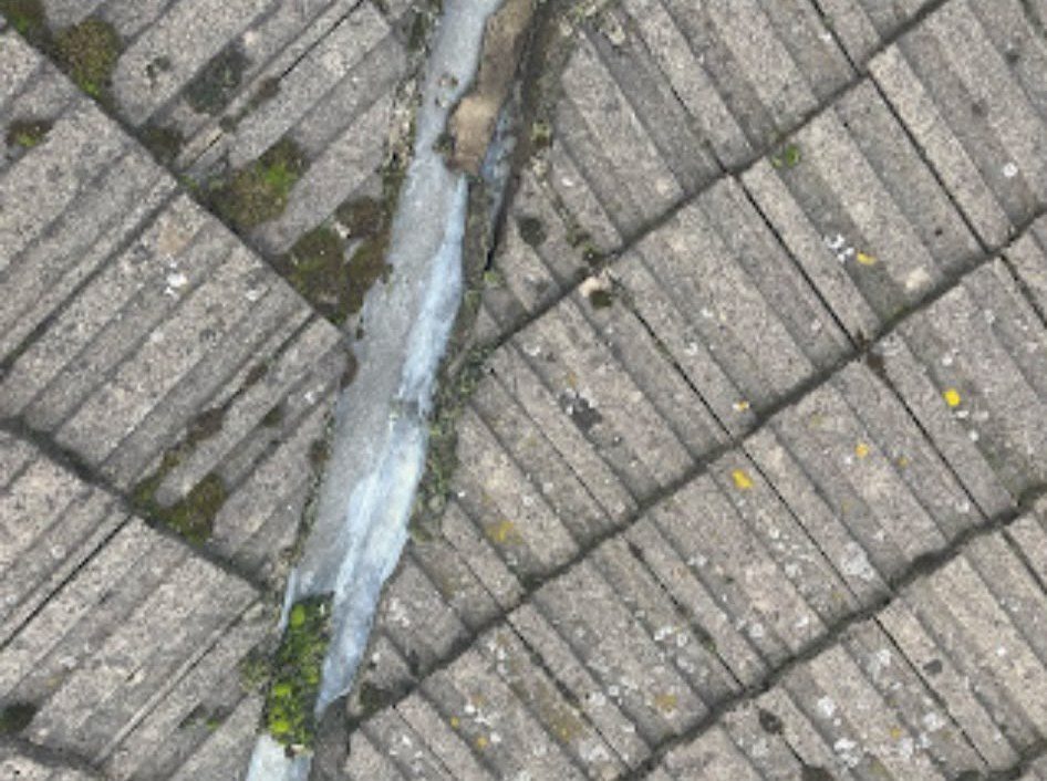 Moss-covered worn roof tiles needing repair