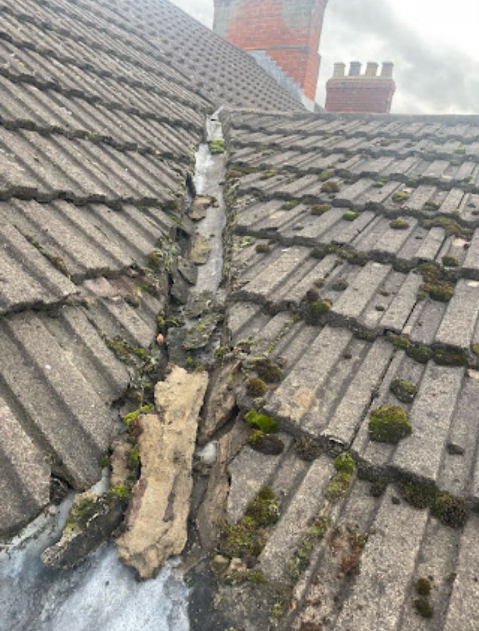 Cracked and weathered roof tiles before repair